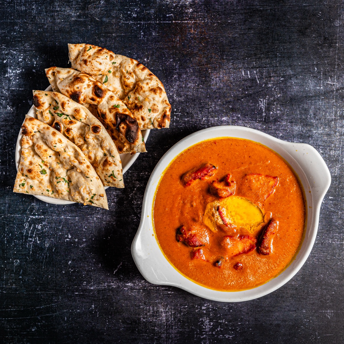 Creamy curry served with freshly baked naan